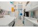 Bright laundry room features abundant white cabinetry, washer, dryer, and adjacent bathroom with walk-in shower at 1724 Amberwynd W Cir, Palmetto, FL 34221