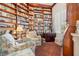 Cozy library with floor to ceiling bookshelves, sitting area, and bright window at 1724 Amberwynd W Cir, Palmetto, FL 34221