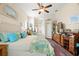 Comfortable main bedroom features a large bed, ceiling fan, and dual closets with ample space at 1724 Amberwynd W Cir, Palmetto, FL 34221