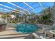 Sparkling screened-in pool, surrounded by ample seating and lush landscaping, for the ultimate relaxation at 1724 Amberwynd W Cir, Palmetto, FL 34221