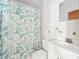 Bathroom featuring a white sink, toilet, and floral shower curtain at 1801 E Mcberry St, Tampa, FL 33610