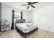 Bedroom featuring a ceiling fan, tiled flooring, and natural light from the window with dark curtains at 1801 E Mcberry St, Tampa, FL 33610