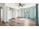 Bedroom featuring hard wood floors, a large window, and closet space at 1801 E Mcberry St, Tampa, FL 33610