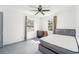 Bedroom featuring a ceiling fan, two windows for natural light, and a dresser at 1801 E Mcberry St, Tampa, FL 33610