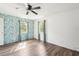 Bedroom featuring hardwood floors, two windows for natural light, and closet space at 1801 E Mcberry St, Tampa, FL 33610