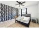 Bedroom featuring striking accent wall, neutral tile floor, and natural light at 1801 E Mcberry St, Tampa, FL 33610