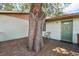 Home's covered wooden deck showing the mature tree and front door access at 1801 E Mcberry St, Tampa, FL 33610