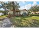 Charming single-story home featuring a well-maintained lawn and inviting front porch at 1801 E Mcberry St, Tampa, FL 33610