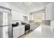 Bright kitchen featuring white cabinets, stainless steel appliances, and marble countertops at 1801 E Mcberry St, Tampa, FL 33610