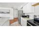 Bright kitchen features white cabinets, stainless steel appliances, and eat-in countertop at 1801 E Mcberry St, Tampa, FL 33610
