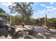 Backyard brick patio with a cozy seating area, chiminea, and lush landscaping at 1904 Pepperwood Pl, Brandon, FL 33510