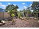 Landscaped backyard showcasing multiple garden areas, pergola and fencing at 1904 Pepperwood Pl, Brandon, FL 33510
