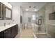 Modern bathroom featuring a double vanity, standalone tub, walk-in shower with glass door, and tiled floors at 1904 Pepperwood Pl, Brandon, FL 33510