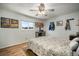 Comfortable bedroom features natural light, ceiling fan, and charming decor accents at 1904 Pepperwood Pl, Brandon, FL 33510