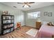 Bedroom with wood-look flooring, soft lighting, and closet at 1904 Pepperwood Pl, Brandon, FL 33510