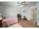 Bright bedroom with a window, wood-look floors, and vintage furniture at 1904 Pepperwood Pl, Brandon, FL 33510