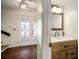 Welcoming entryway with decorative glass doors and convenient half bath at 1904 Pepperwood Pl, Brandon, FL 33510