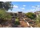 Landscaped garden with raised garden beds, a stone privacy wall and pergola at 1904 Pepperwood Pl, Brandon, FL 33510