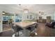 Kitchen island with bar stools and open layout to dining area at 1904 Pepperwood Pl, Brandon, FL 33510