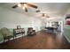 Spacious living room featuring wood floors, seating, and open access to the kitchen at 1904 Pepperwood Pl, Brandon, FL 33510