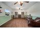 Bright and airy living room with wood look floors, green wainscoting, and shelving at 1904 Pepperwood Pl, Brandon, FL 33510