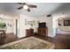 Cozy living room with wood floors, ceiling fan, and eclectic furnishings at 1904 Pepperwood Pl, Brandon, FL 33510