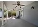 Covered outdoor patio featuring ceiling fans, flagstone flooring, and comfortable seating at 1904 Pepperwood Pl, Brandon, FL 33510