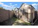 Backyard with two storage sheds, and a stone privacy wall at 1904 Pepperwood Pl, Brandon, FL 33510