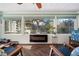 Bright sunroom with ample windows, a ceiling fan, and modern fireplace at 1904 Pepperwood Pl, Brandon, FL 33510