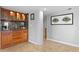 Custom bar area features wood cabinetry, granite countertop, and built-in display cases at 201 W Laurel St # 1006, Tampa, FL 33602