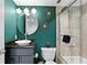 Stylish bathroom featuring green walls, decorative starbursts, and a modern vanity and shower at 201 W Laurel St # 1006, Tampa, FL 33602