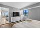 Bedroom featuring a large bed, hardwood floors, city view window, and modern decor at 201 W Laurel St # 1006, Tampa, FL 33602