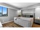 Well-lit bedroom with hardwood floors, large bed, city view window, and modern decor at 201 W Laurel St # 1006, Tampa, FL 33602