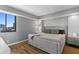 Stylish bedroom with large bed, wood floors, city view window, and modern decor at 201 W Laurel St # 1006, Tampa, FL 33602