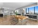 Bright dining room features modern transparent chairs and a large window with city views at 201 W Laurel St # 1006, Tampa, FL 33602