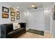 Elegant entryway with a black leather bench, unique tiger rug, and white double doors at 201 W Laurel St # 1006, Tampa, FL 33602