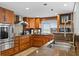 Classic kitchen with wood cabinets, granite counters, a wine cooler, and stainless steel appliances at 201 W Laurel St # 1006, Tampa, FL 33602
