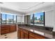 Gourmet kitchen with wood cabinetry, granite countertops, breakfast bar, and a stunning city view at 201 W Laurel St # 1006, Tampa, FL 33602