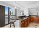 Kitchen boasts granite counters, wooden cabinets, stainless appliances, and city views at 201 W Laurel St # 1006, Tampa, FL 33602