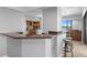 Modern kitchen featuring a breakfast bar with granite countertops and seating at 201 W Laurel St # 1006, Tampa, FL 33602