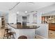 Spacious kitchen with breakfast bar, stainless steel refrigerator, spiral staircase, and modern design at 201 W Laurel St # 1006, Tampa, FL 33602