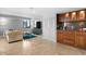 Open-concept living room with stylish wet bar, comfortable seating, and city skyline views at 201 W Laurel St # 1006, Tampa, FL 33602