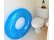 Bright bathroom features a standard toilet with a decorative lighthouse on top of the tank at 2329 Como St, Port Charlotte, FL 33948