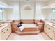 A bright bathroom featuring a standalone tub, dual sinks, and decorative lighting at 2329 Como St, Port Charlotte, FL 33948