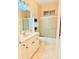 Bright bathroom features a shower-tub combo, neutral tile, and a vanity with storage at 2329 Como St, Port Charlotte, FL 33948