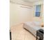 Bedroom features light walls, tile flooring, and 'Live Laugh Love' decor at 2329 Como St, Port Charlotte, FL 33948