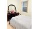 Bright bedroom with tiled floors, complemented by a dresser with mirror at 2329 Como St, Port Charlotte, FL 33948
