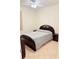 Well-lit bedroom featuring tile flooring and dark wood bedroom furniture at 2329 Como St, Port Charlotte, FL 33948