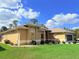 Image of side of house with lush lawn and manicured landscaping at 2329 Como St, Port Charlotte, FL 33948