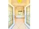 View of a spacious foyer featuring a tiled floor, ornate tray ceiling, and a front door with glass inlays at 2329 Como St, Port Charlotte, FL 33948